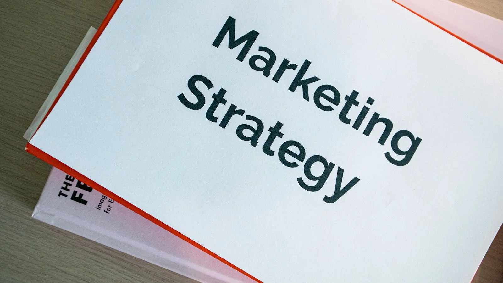 Binders and marketing materials organized on a table, the structured backbone of a content hub