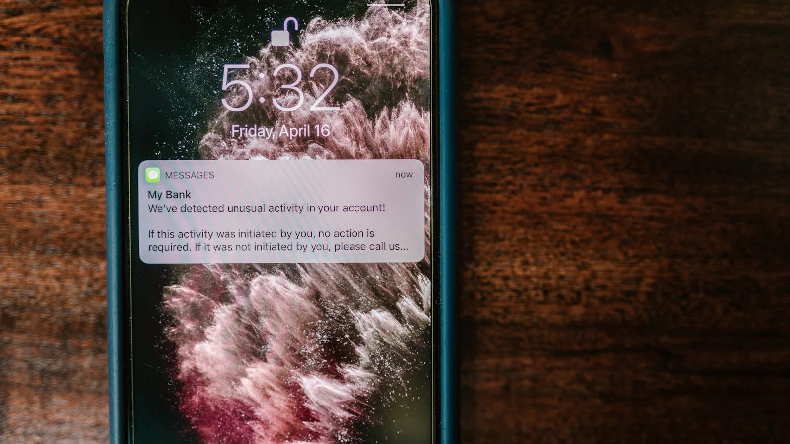 Phone showing a notification on a wooden desk, the moment most crisis cycles announce themselves to leadership